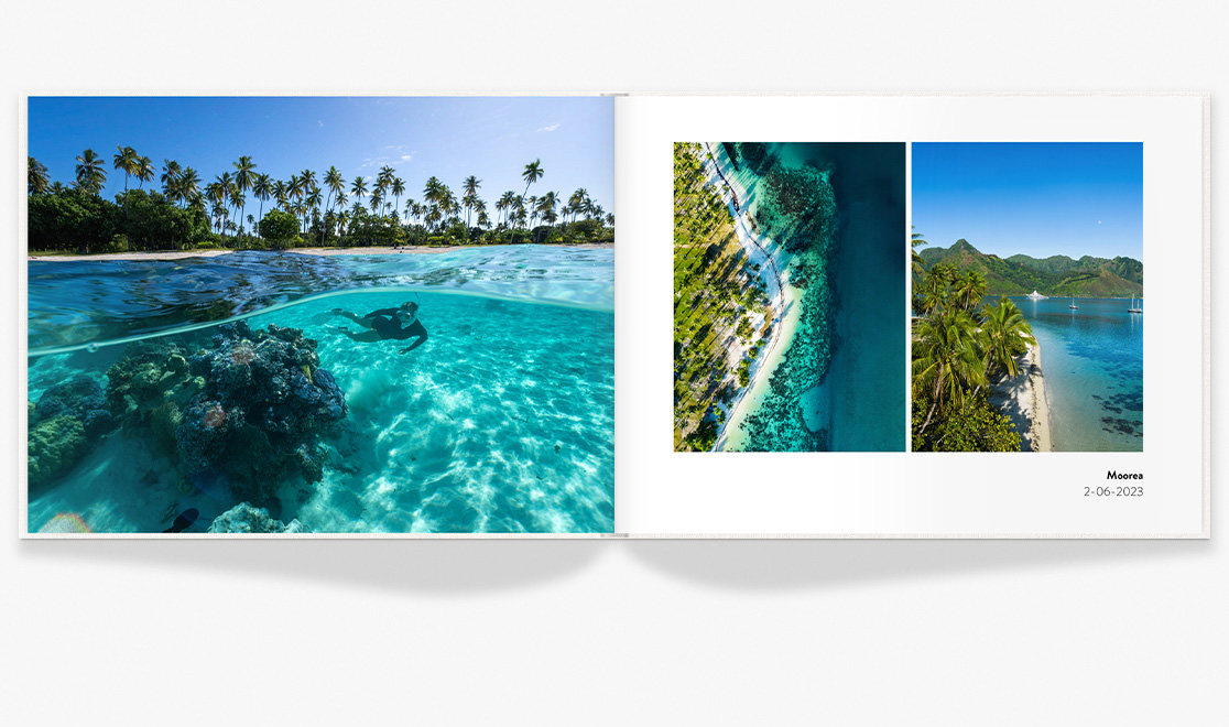 Open Landscape Premium Photo Book with travel photos under a bright blue coral reef and snorkeller.