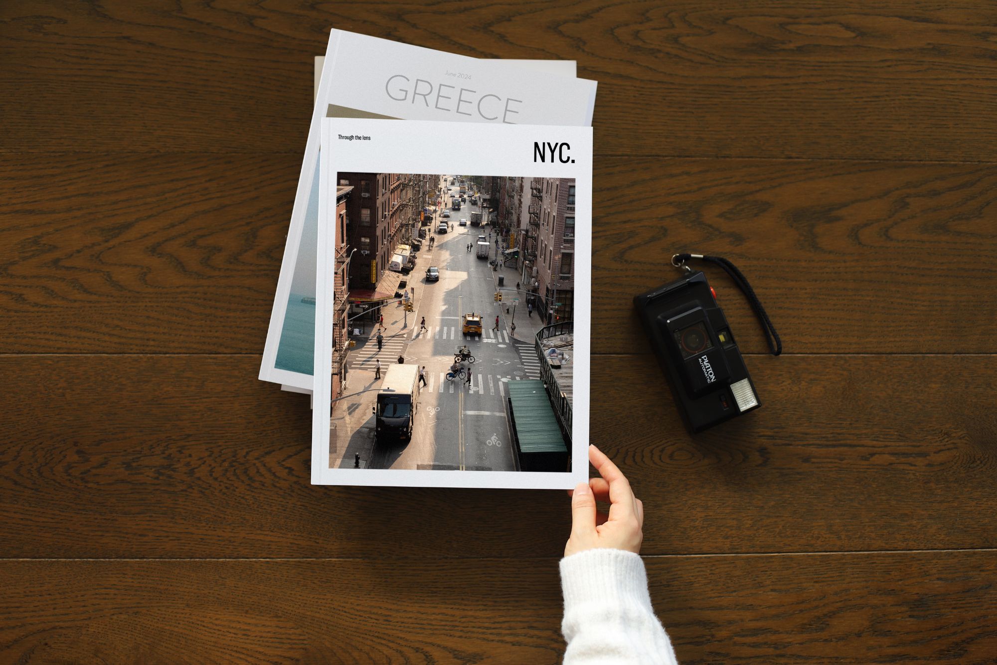 Picking up Magazine from table with NYC up the top