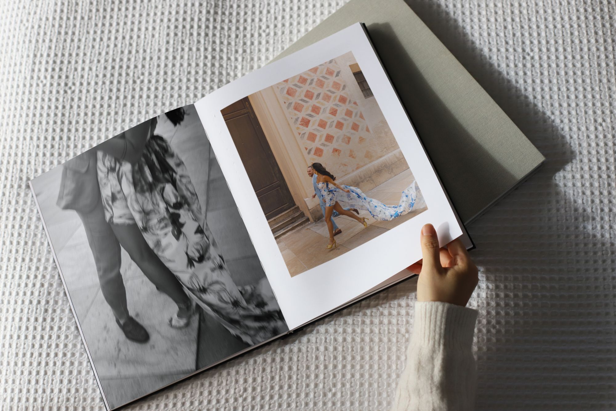 Image of woman flipping throgh a book with lady in a dress page