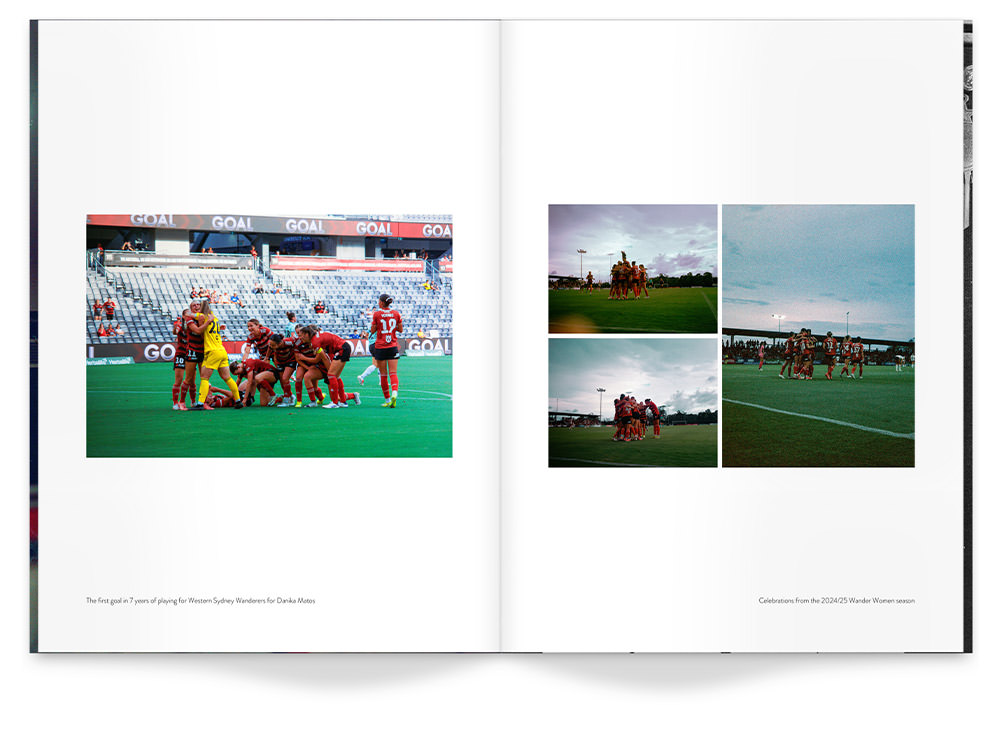 Large Portrait Magazine of women's rugby team smiling together on field in red uniforms.