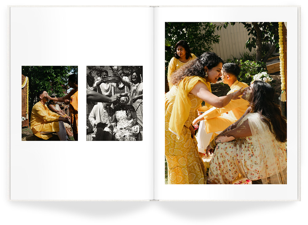 Portrait Premium Photo Book of Indian family in yellow attire smile spreading paste on face of bride at wedding ceremony.