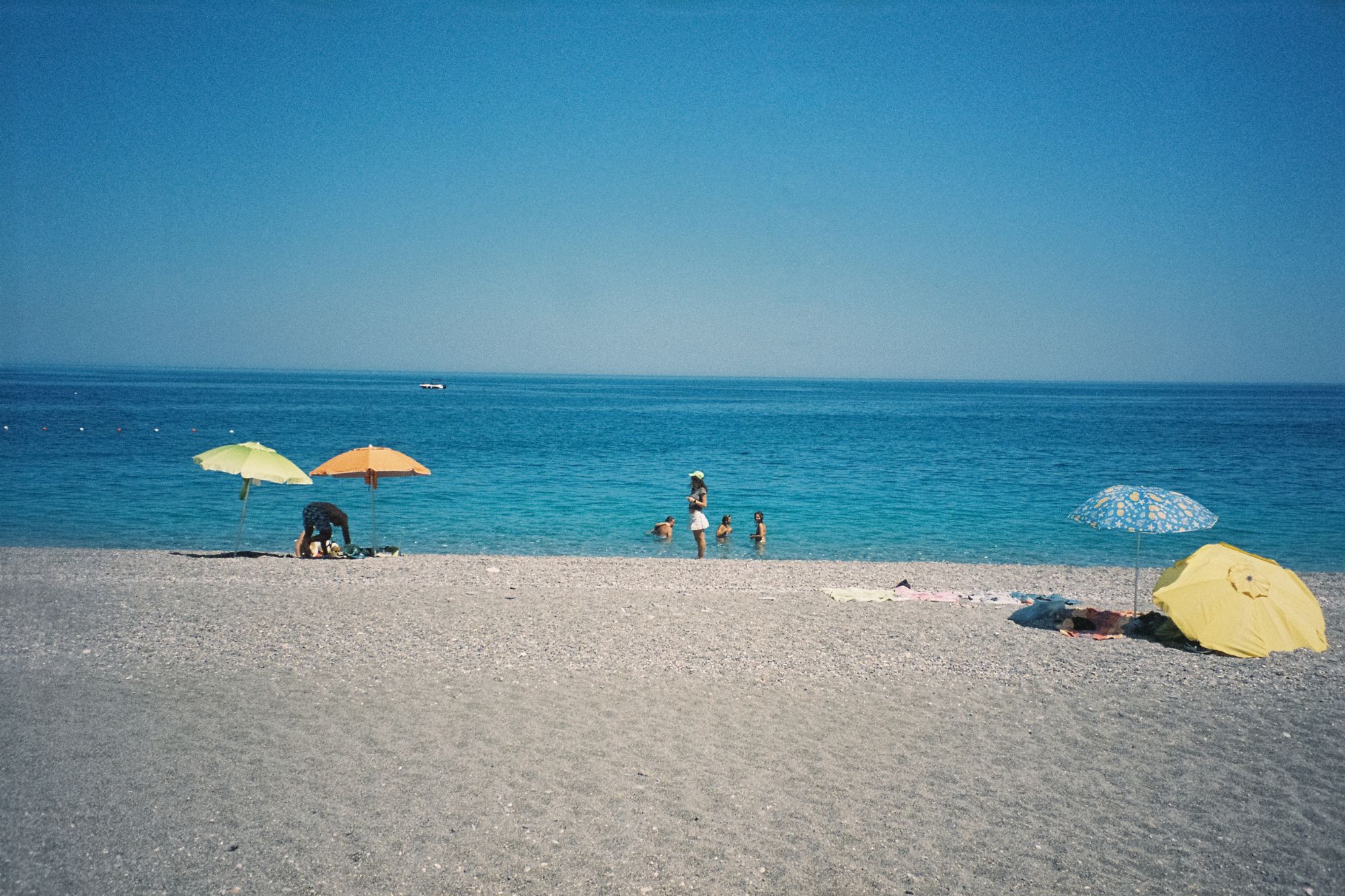 Polaroid photo of people at a beach