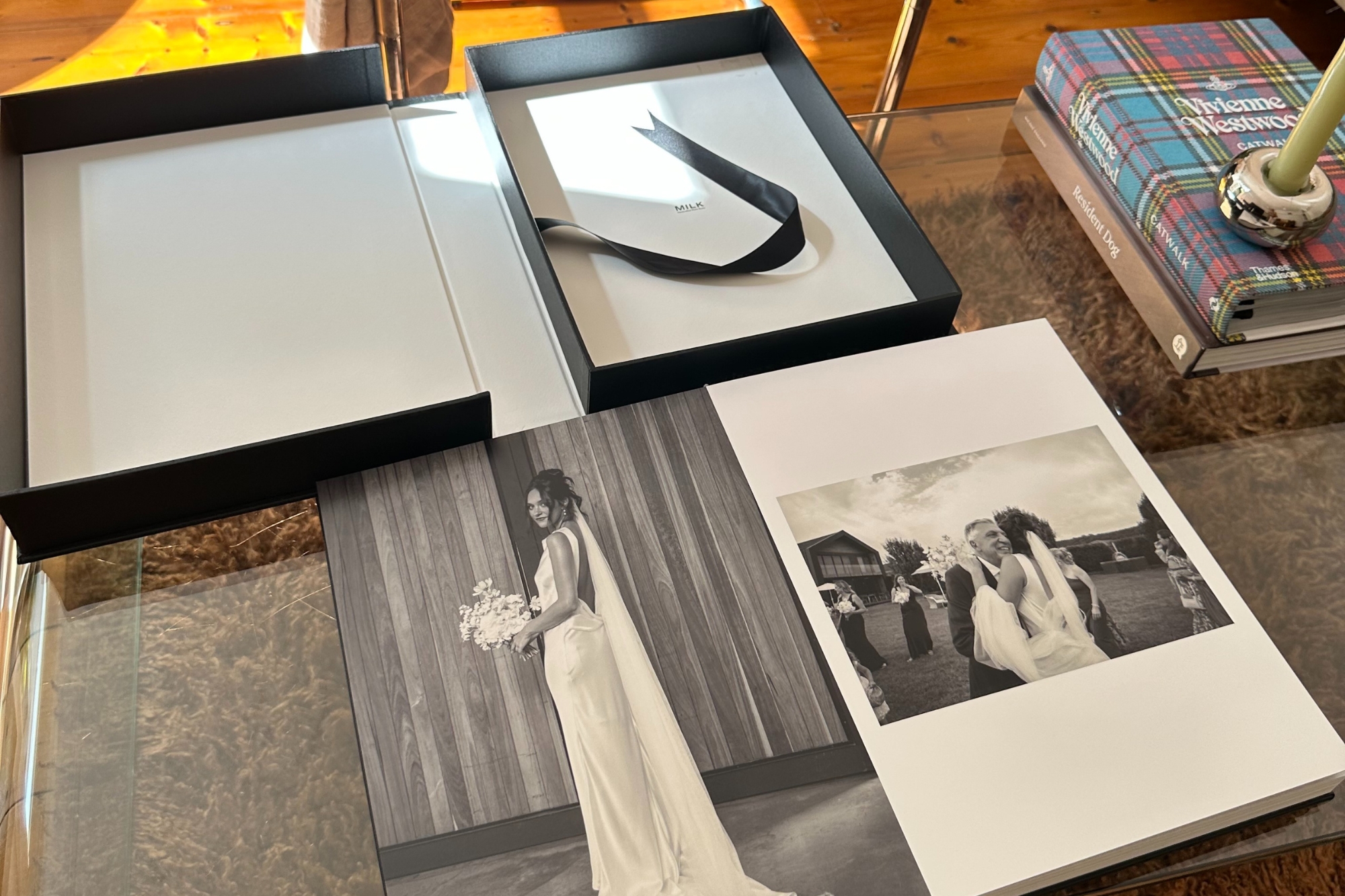 Book open on table with presentation box behind it