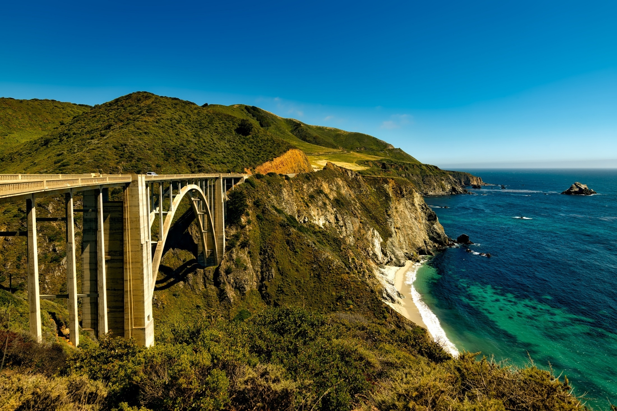 Landscape shot of Pacific Coast Highway, California overlooking the bridge road along the coastline.