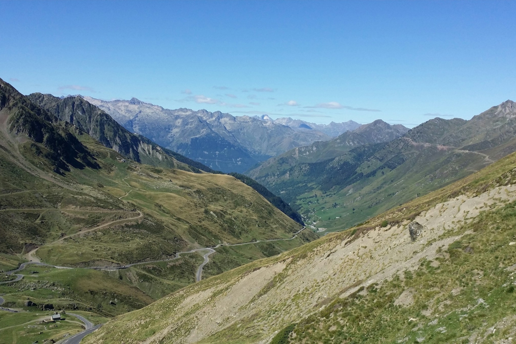 Valley between French Alps with winding road through the crevasse.
