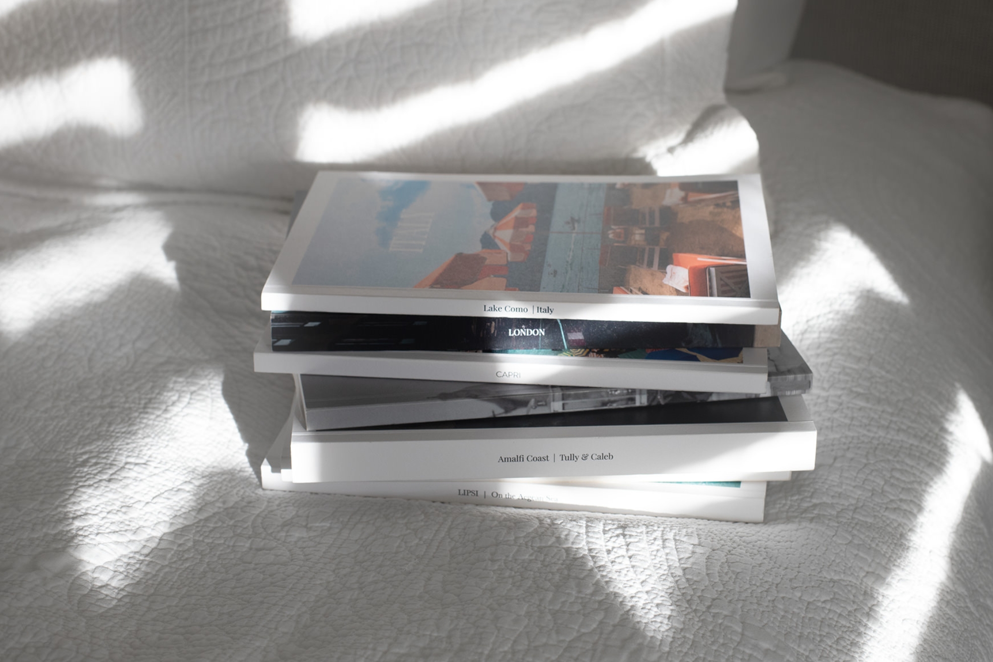 Mini Magazines stacked on a bed