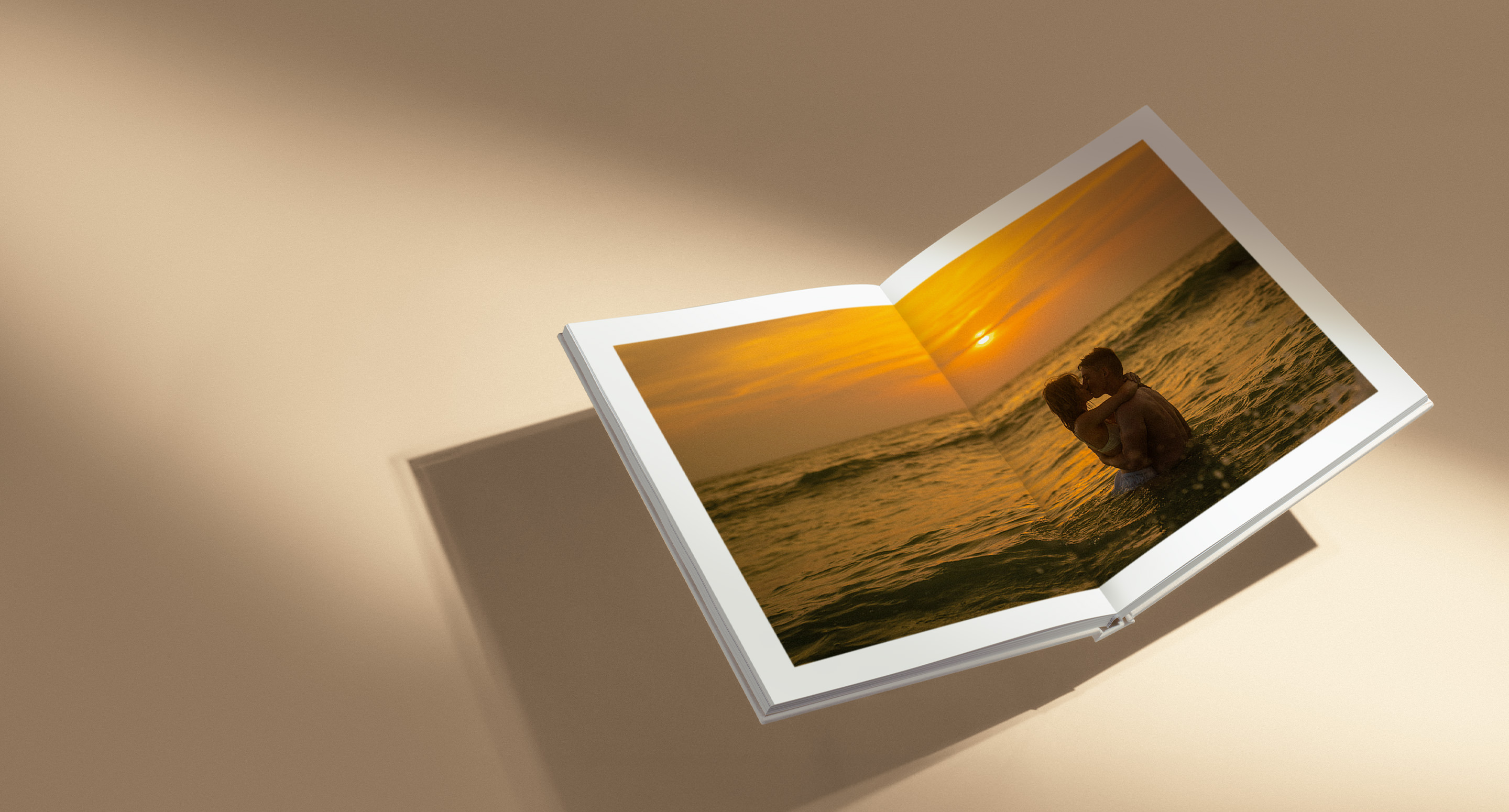 Open Premium Photo Album with photo of couple kissing in ocean at sunset inside double page spread.