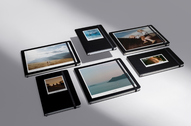 Various Moleskine Photo Book orientations laying on grey background