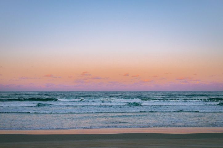 Panoramic beach scene of waves and sand