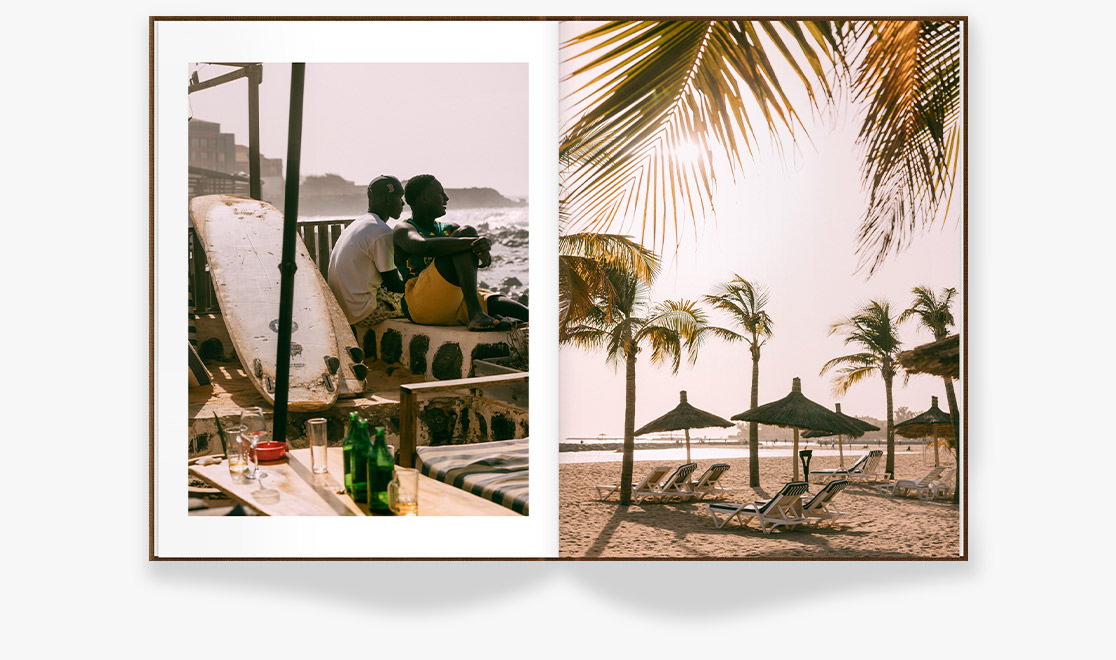 Open Portrait Photo Book with photos of beach in Senegal on double-page spread.