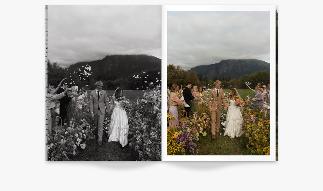Bride smiling with bridesmaids wearing blush toned dresses standing in a field under overcast skies.