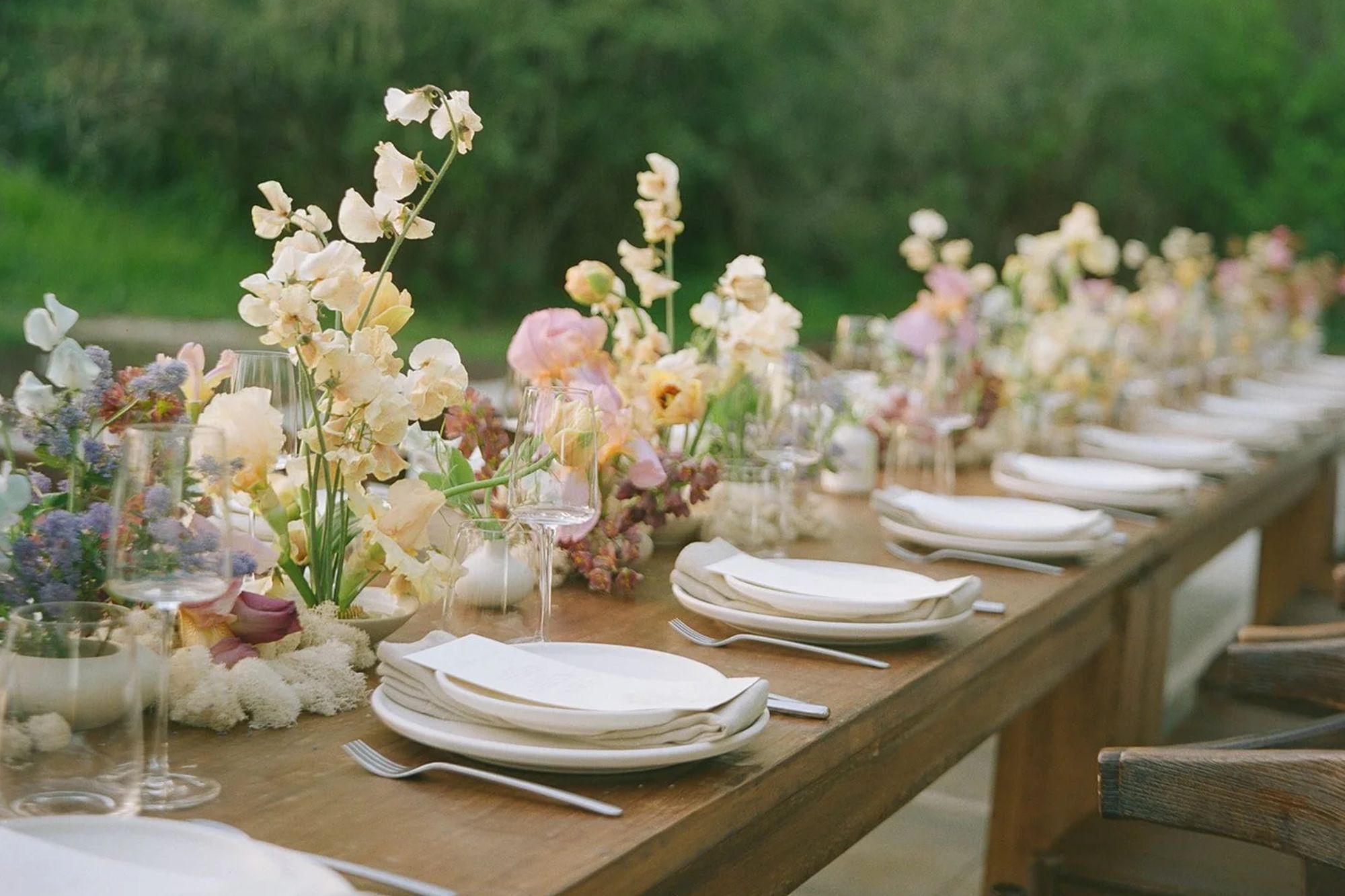 Table spread at wedding with fower arangements
