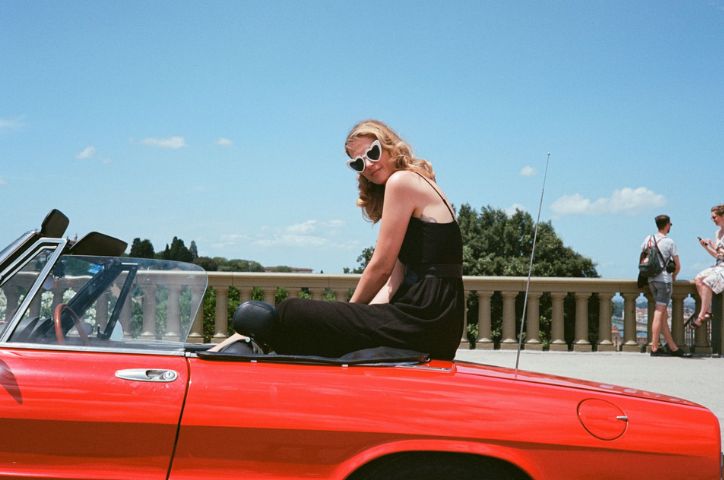Girl sitting on a car