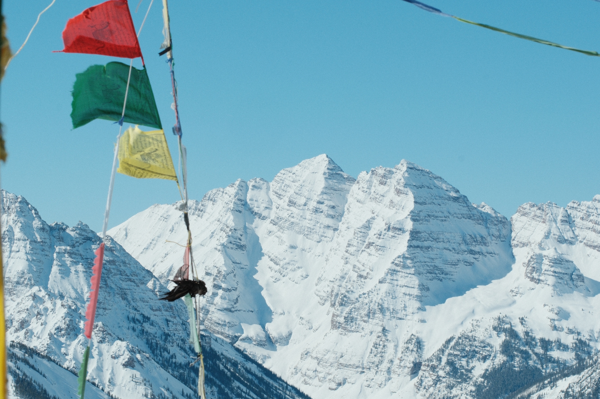 photo of colorful flags on snowy mountains