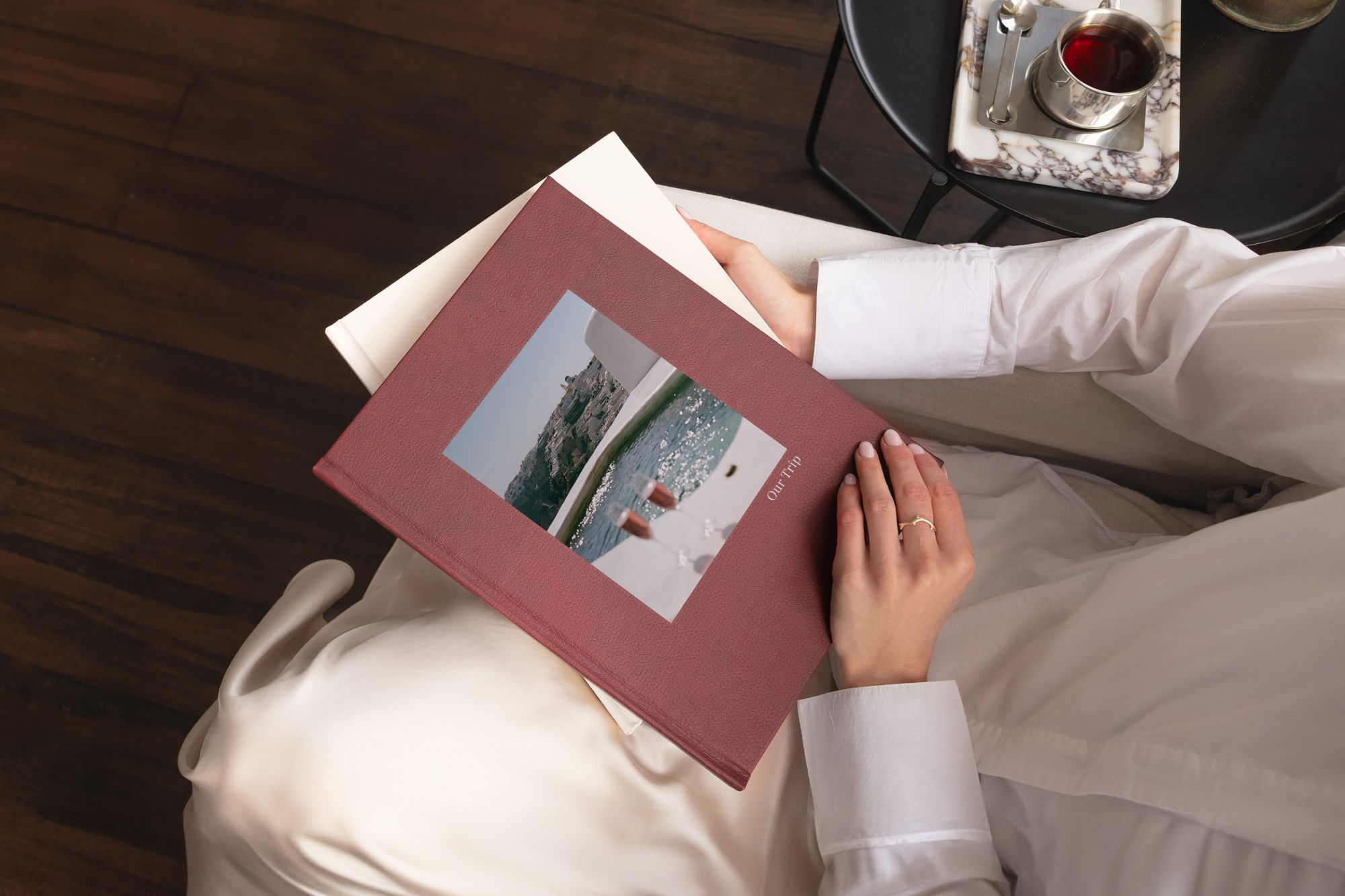 Birds eye view image of girl with book with 'our trip' and image