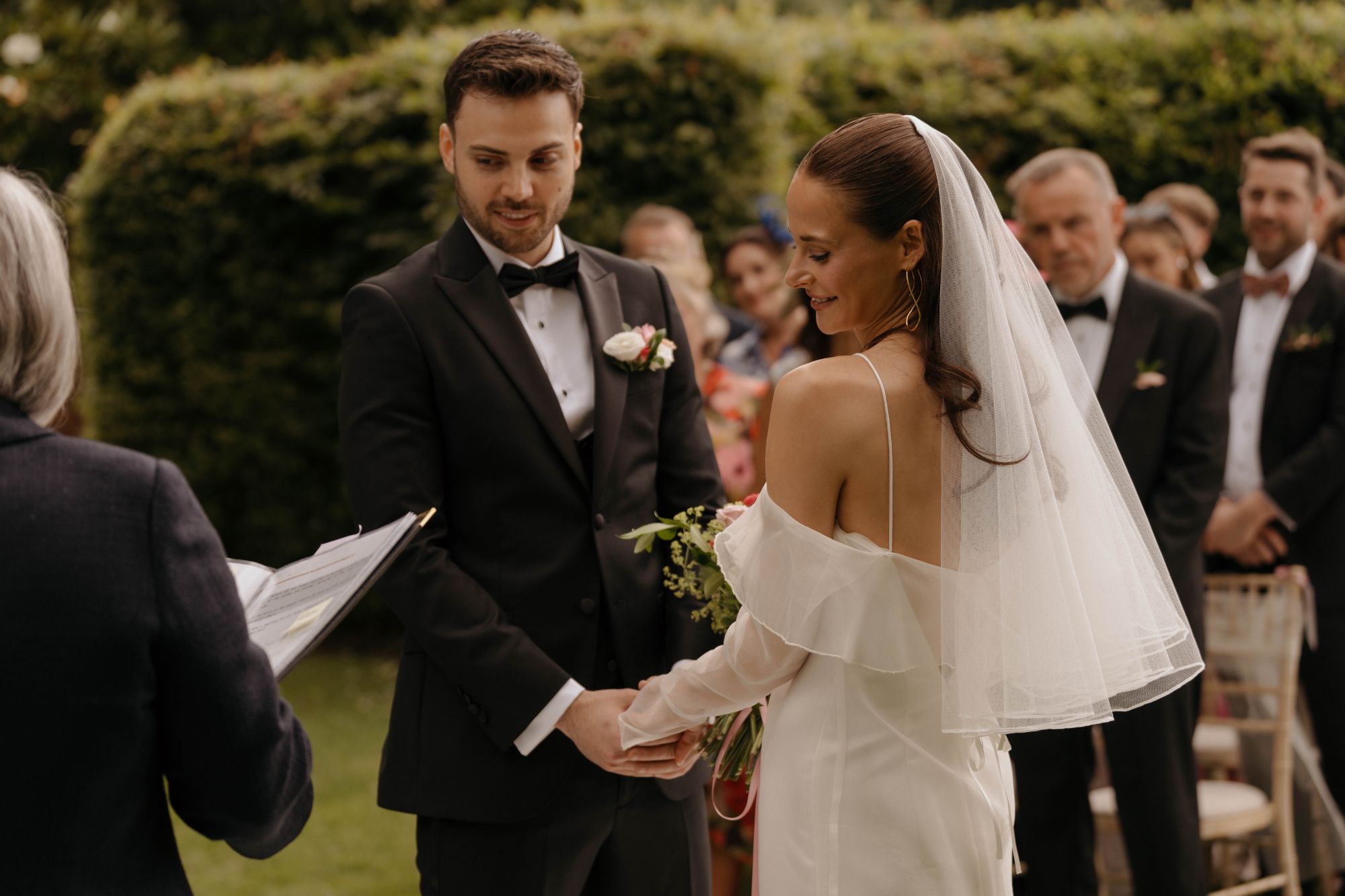 Couple holding hands at the alter