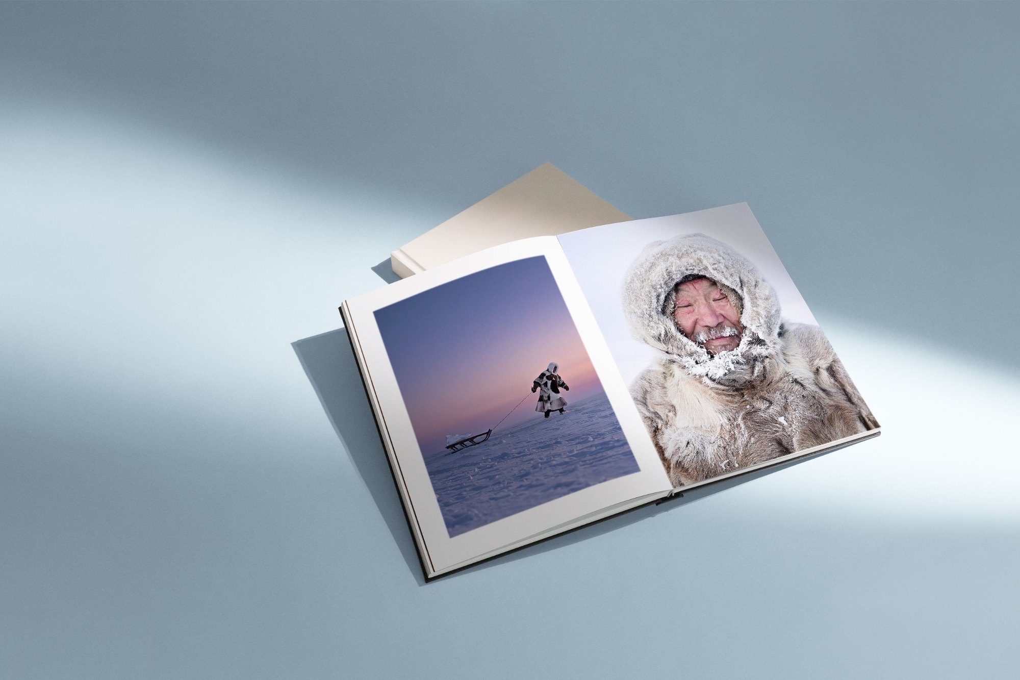 Open MILK Medium Premium Photo Book with photos of Antarctica on double-page spread.