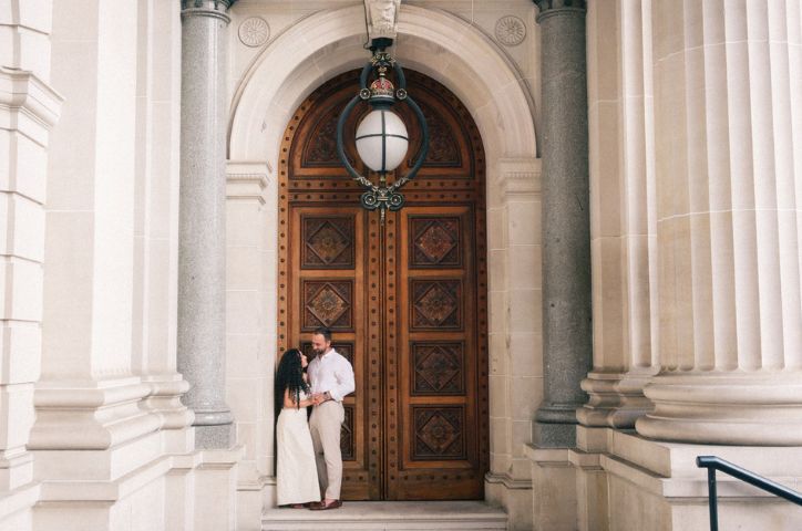 couple standing outside church on wedding day