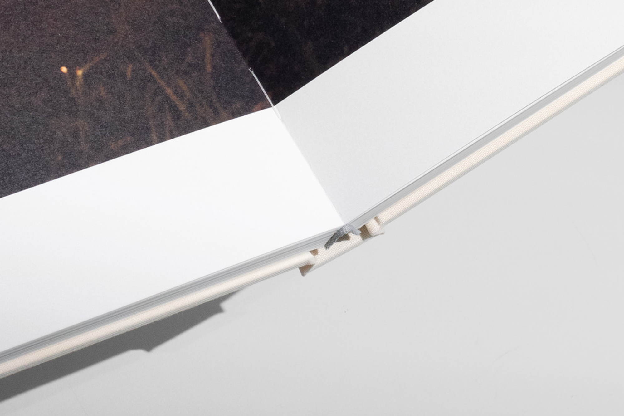 Close-up of section-sewn binding on a Premium Photo Book.