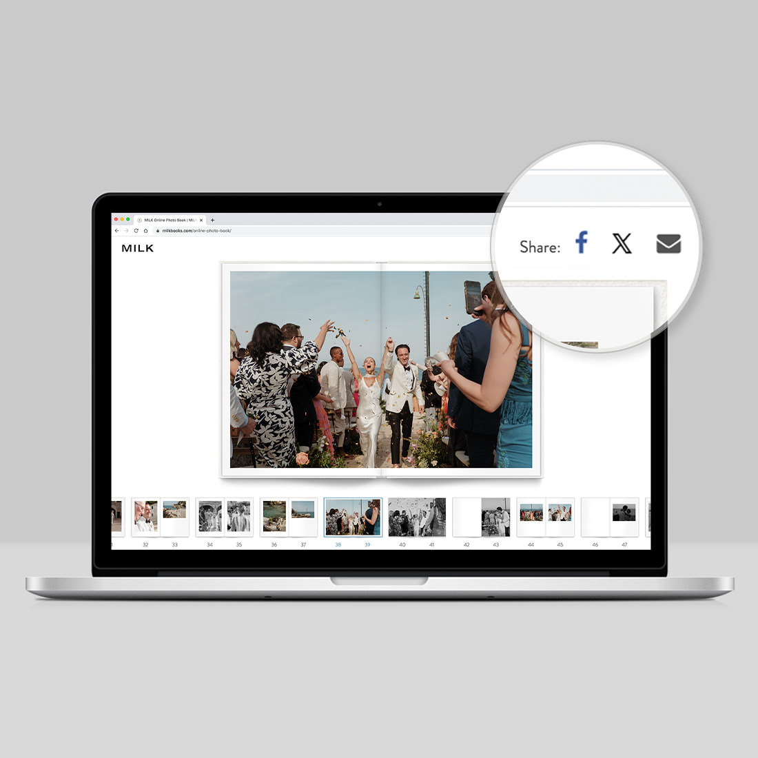 Open laptop with Online Photo Book displayed on screen highlighting the share symbols at top right of screen.