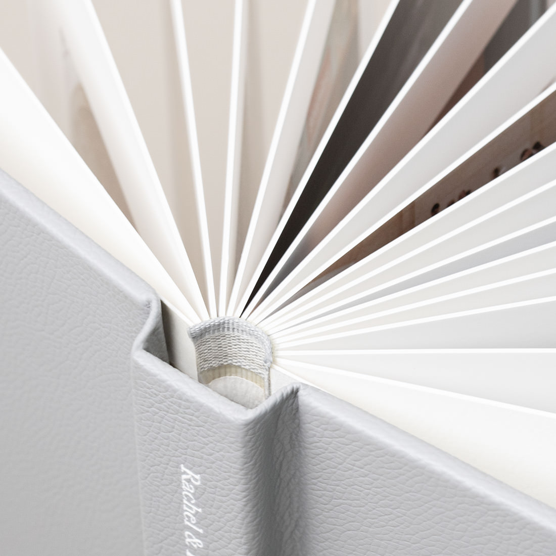 Open Leather Photo Album with paper pages spread out to see thickness.