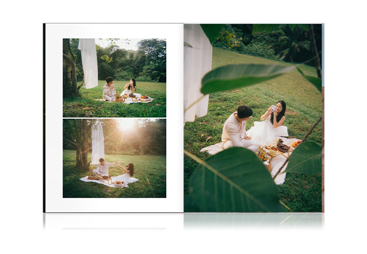 Open Wedding Magazine with couple sharing a picnic in photos on double-page spread.