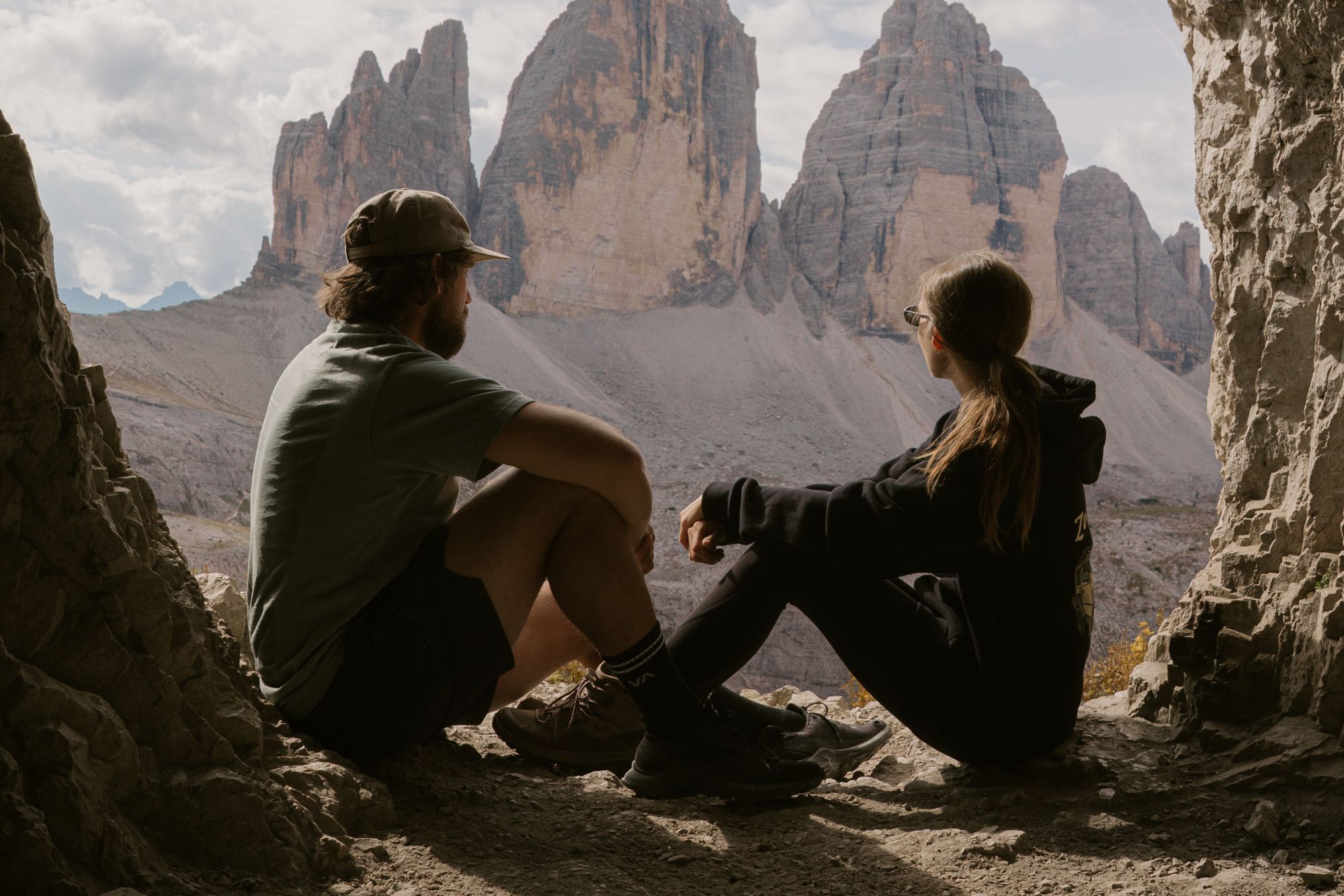 Couple staring into distance surrounded by rocky terrain