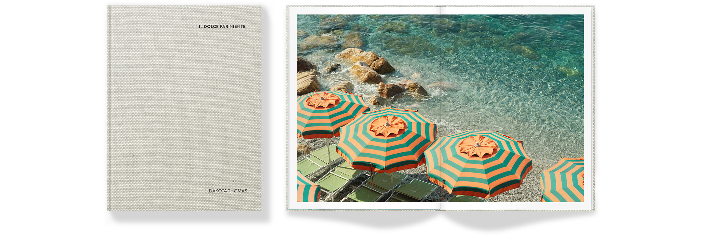 Open Portrait Premium Photo Book showing bright beach with clear turquoise water and matching green and orange umbrellas on the shore.