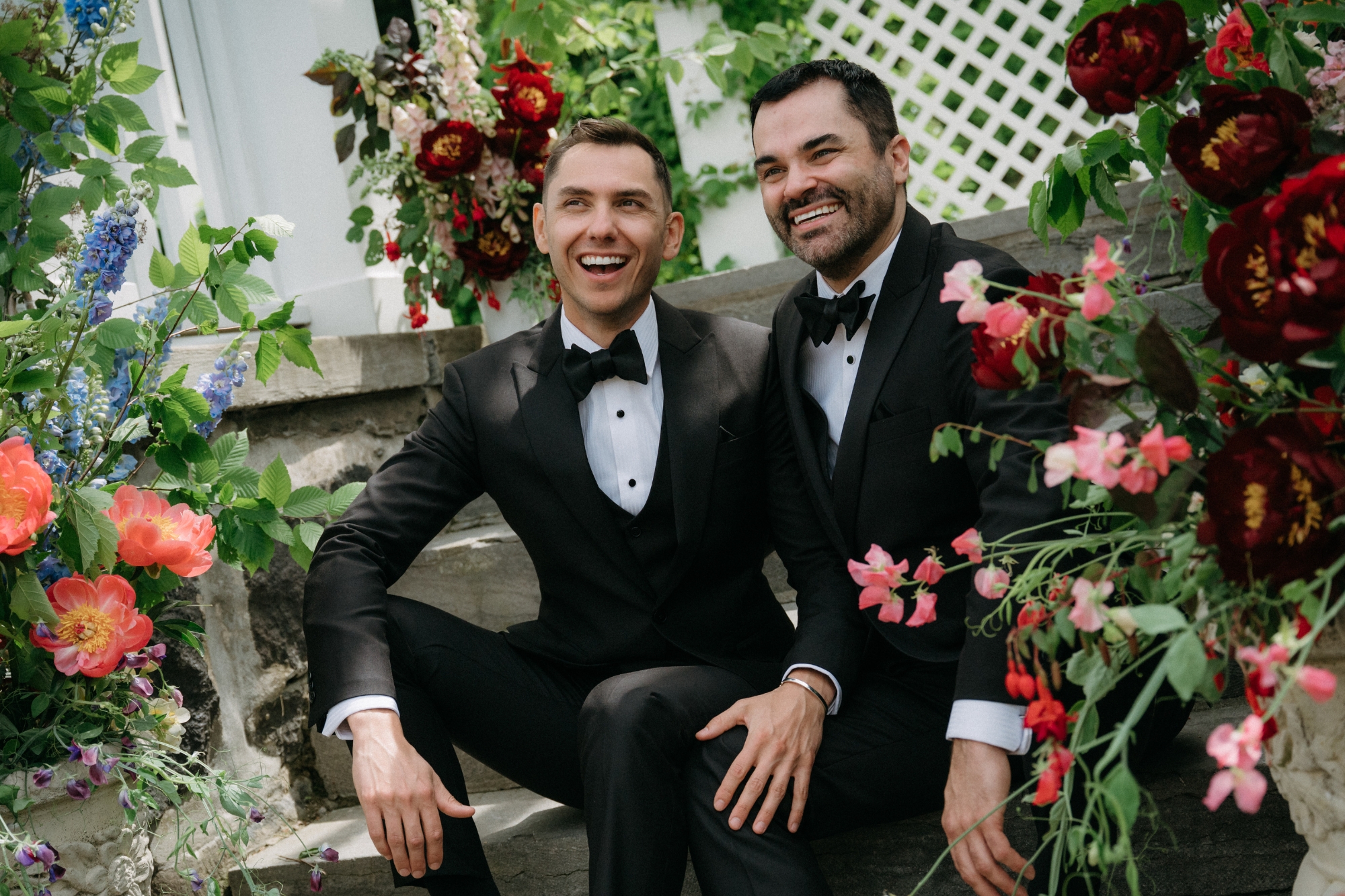 Two guys sitting down smiling