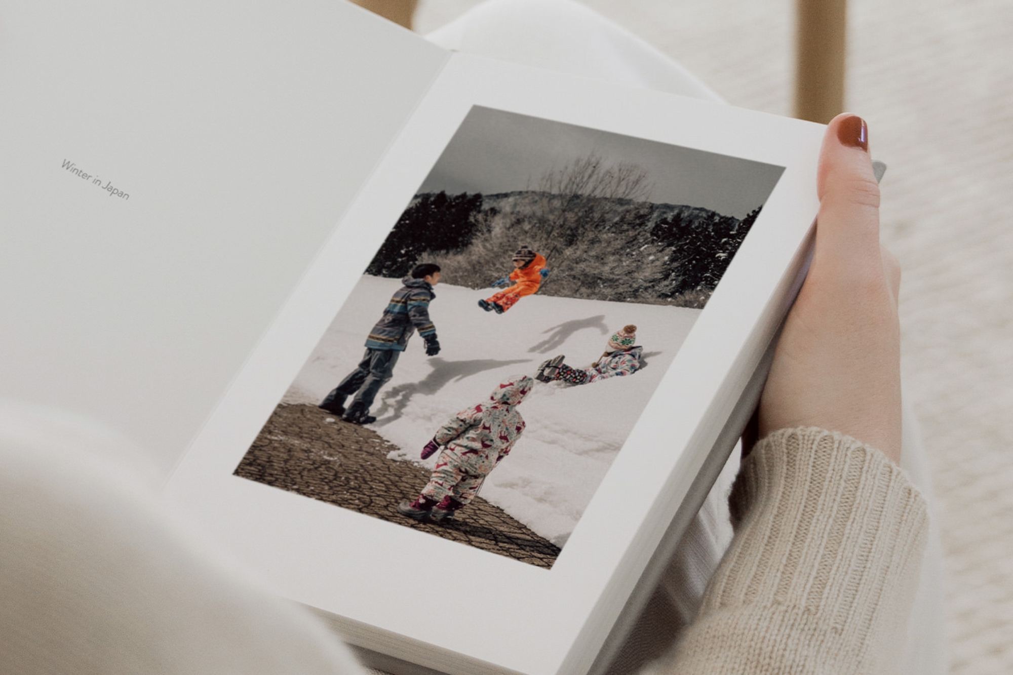 Open Portrait Photo Book with photo of children in the snow.
