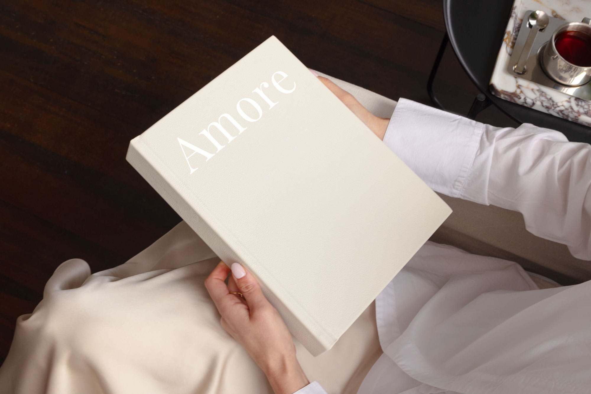 Holding a Large Portrait Leather Photo Album with the word 'amore' on the cover.