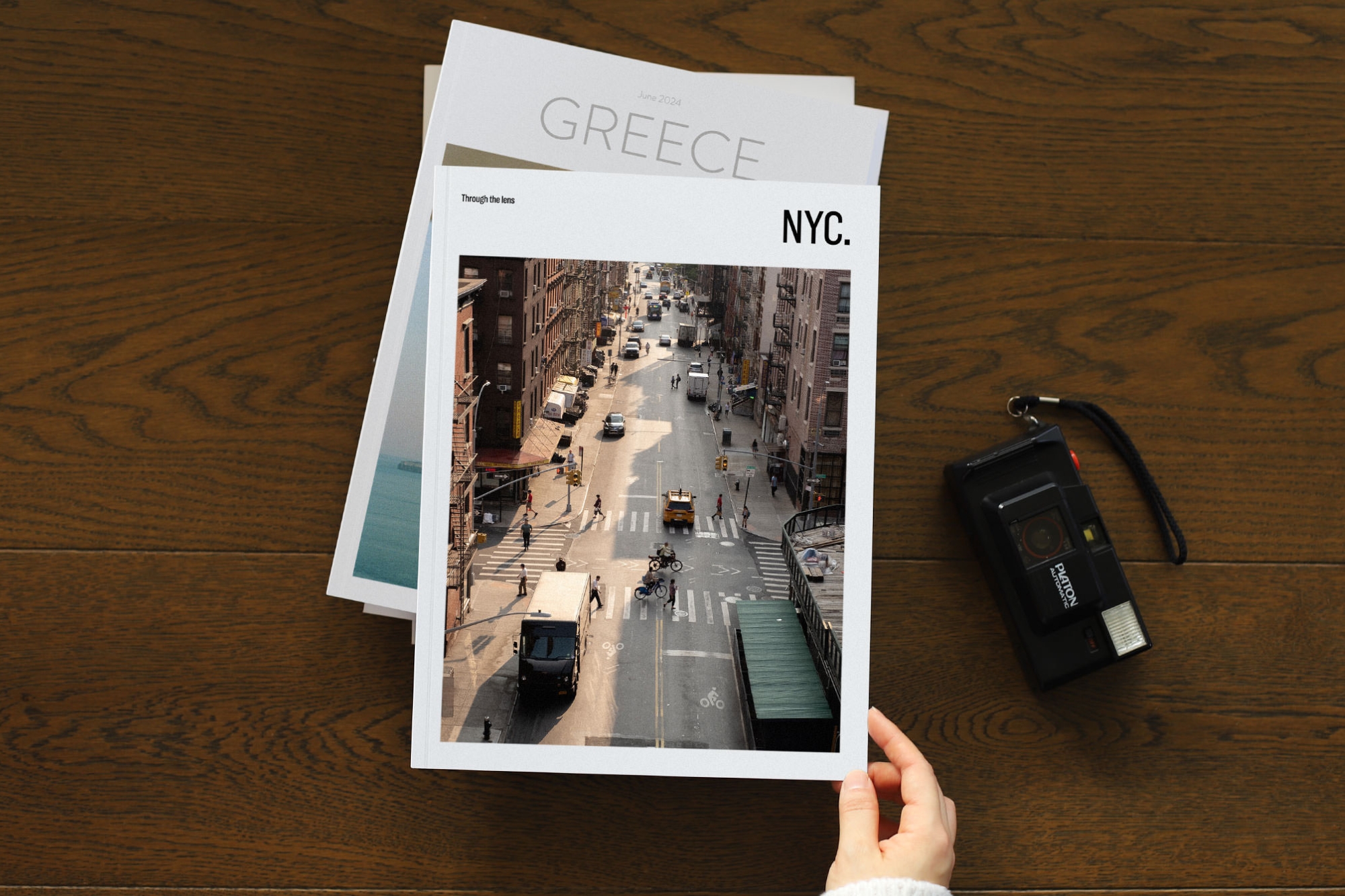 Stack of Travel Magazines on a wood table.
