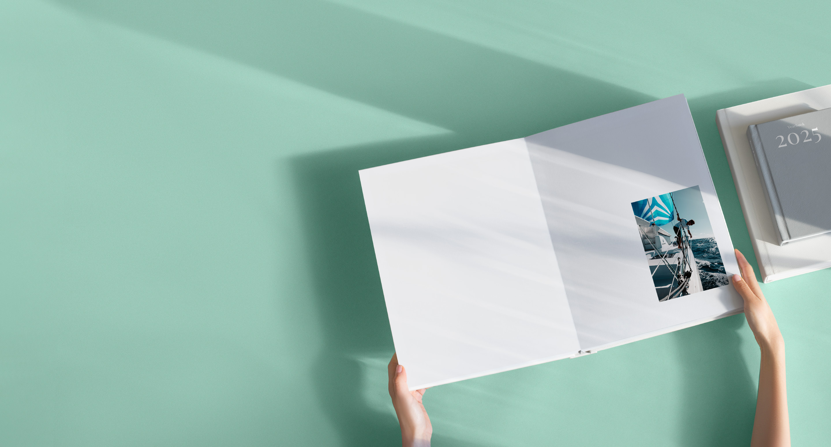 Black gift box wrapped with a velvet black ribbon on shadowy black background.