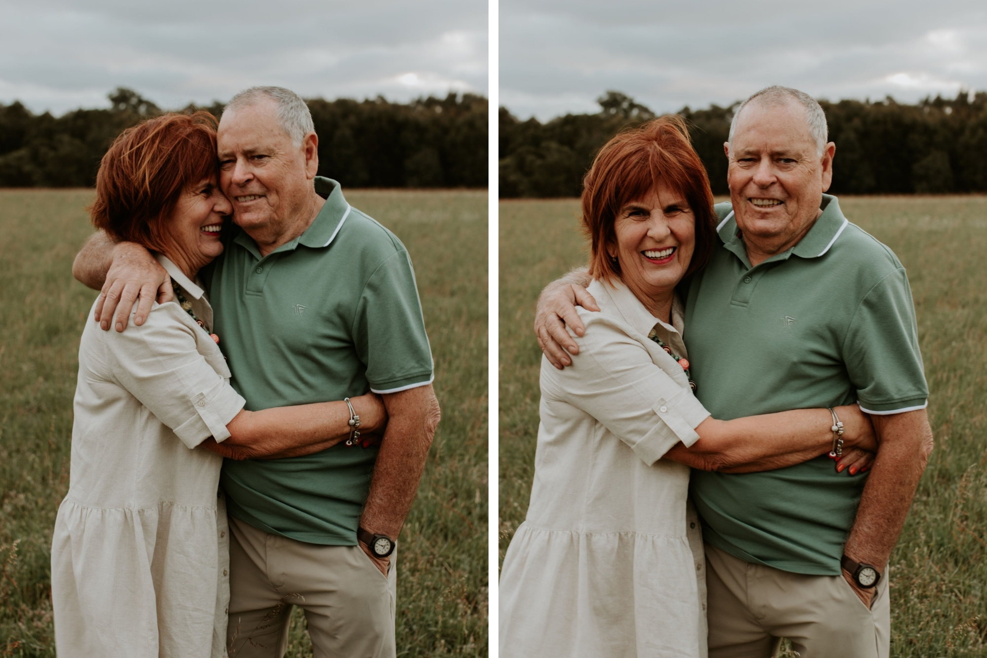 Grandparents hugging in the middle of a grassy field with cloudy skies.