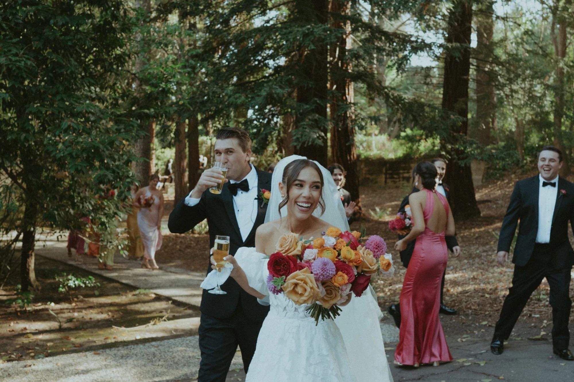 Bride and groom walking down isle with drinks