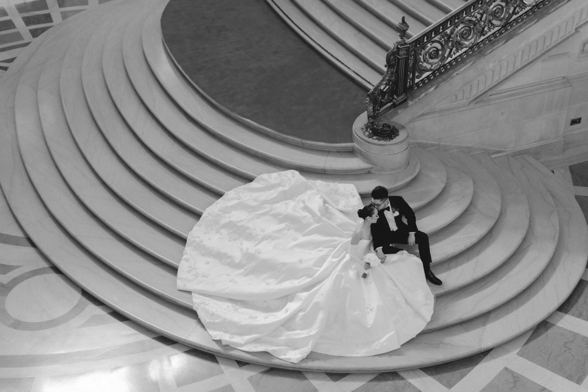 Couple in black and white going down the stairs