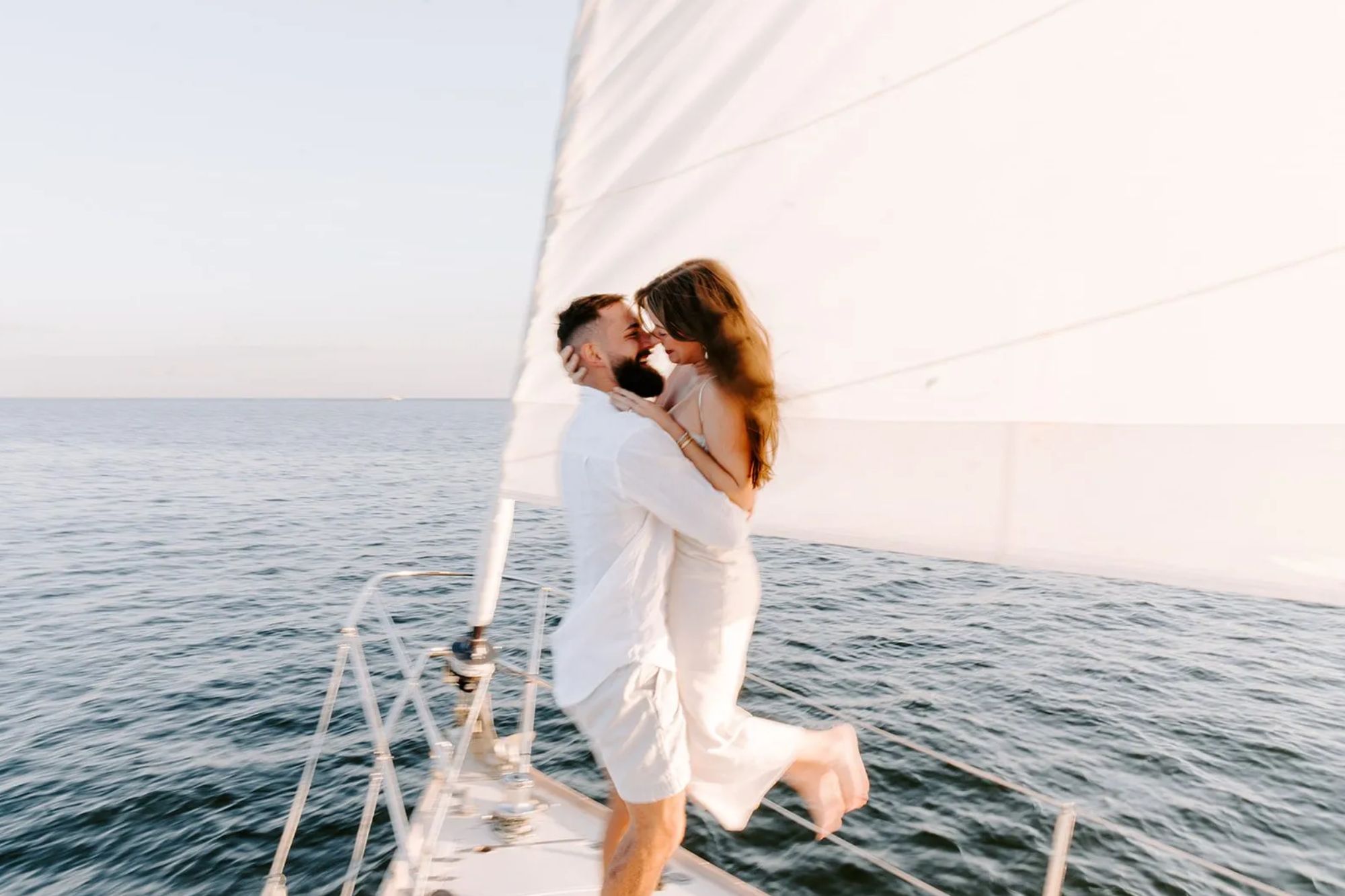 Couple at edge of boat holding eachother