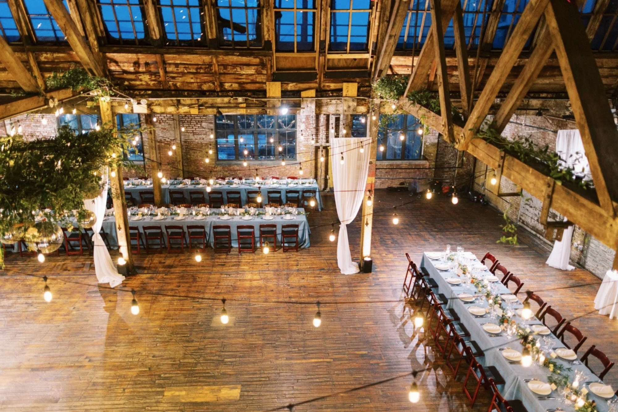 Top-down view of wide area of Greenpoint Loft set up for a wedding reception dining area.
