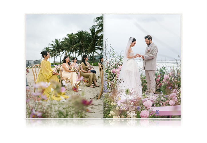 Open Large Portrait Premium Photo Book featuring a wedding on a beach covered in pink, yellow and green florals.