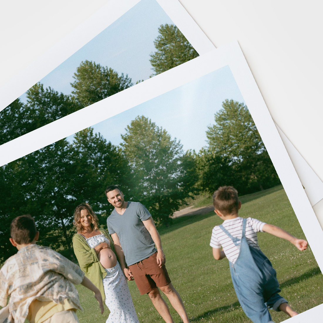 Range of premium papers laid on table with photos of a family printed on the sheets.