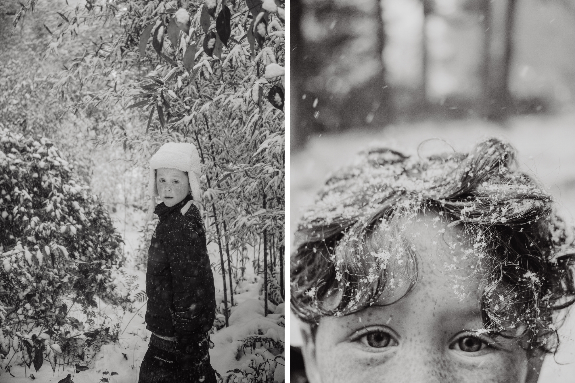 Boy in snow gear walking through heavy snow in forest looking back at camera, covered in snowfall.