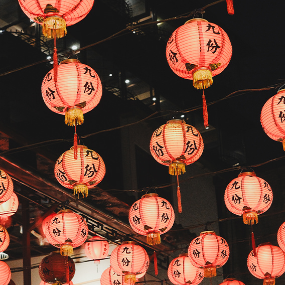 Many red lanterns hang on ceiling.