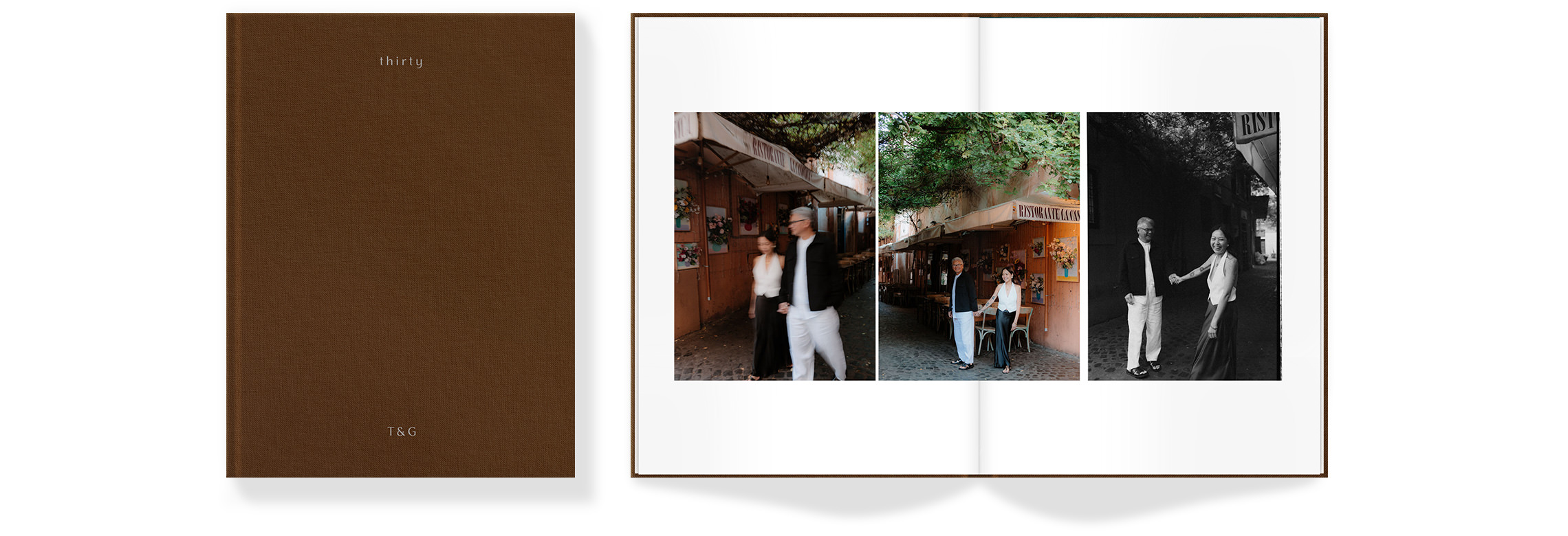 Open Premium Photo Book with photos of couple holding hands walking through cobblestone streets.