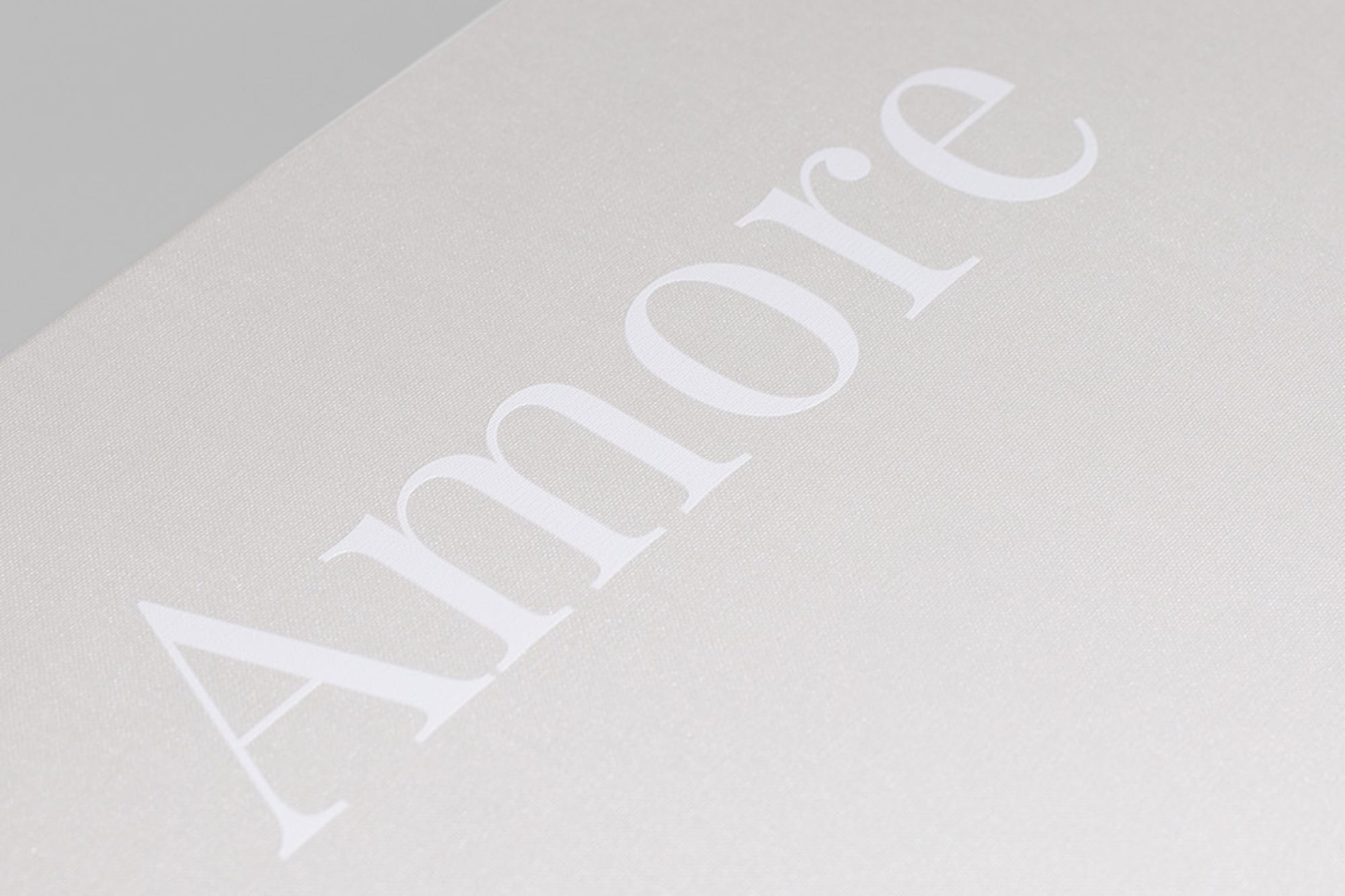 Close-up of 'Amore' text on cover with White UV printed text.