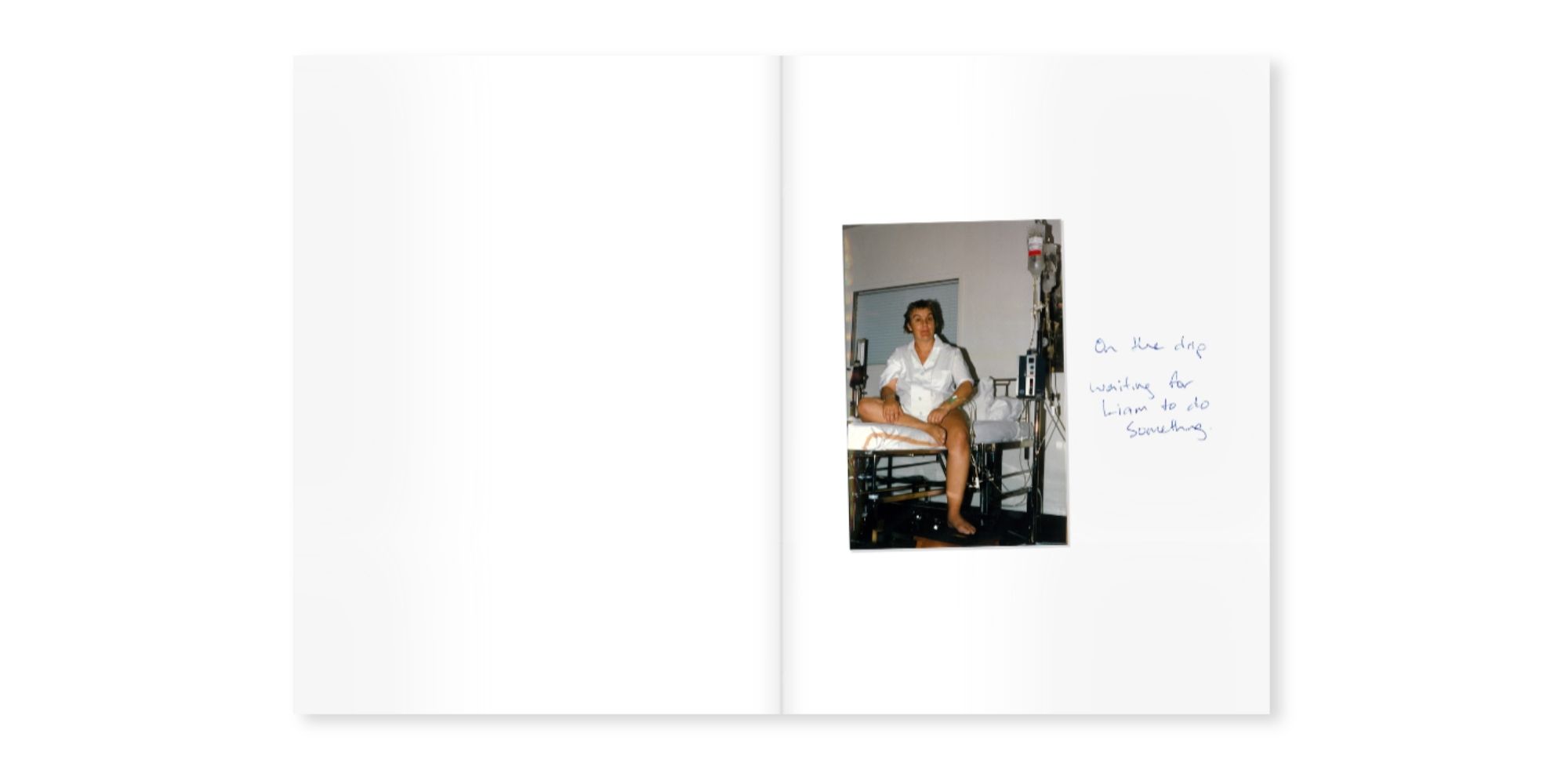 open photo book with a single old photo of woman on hospital bed