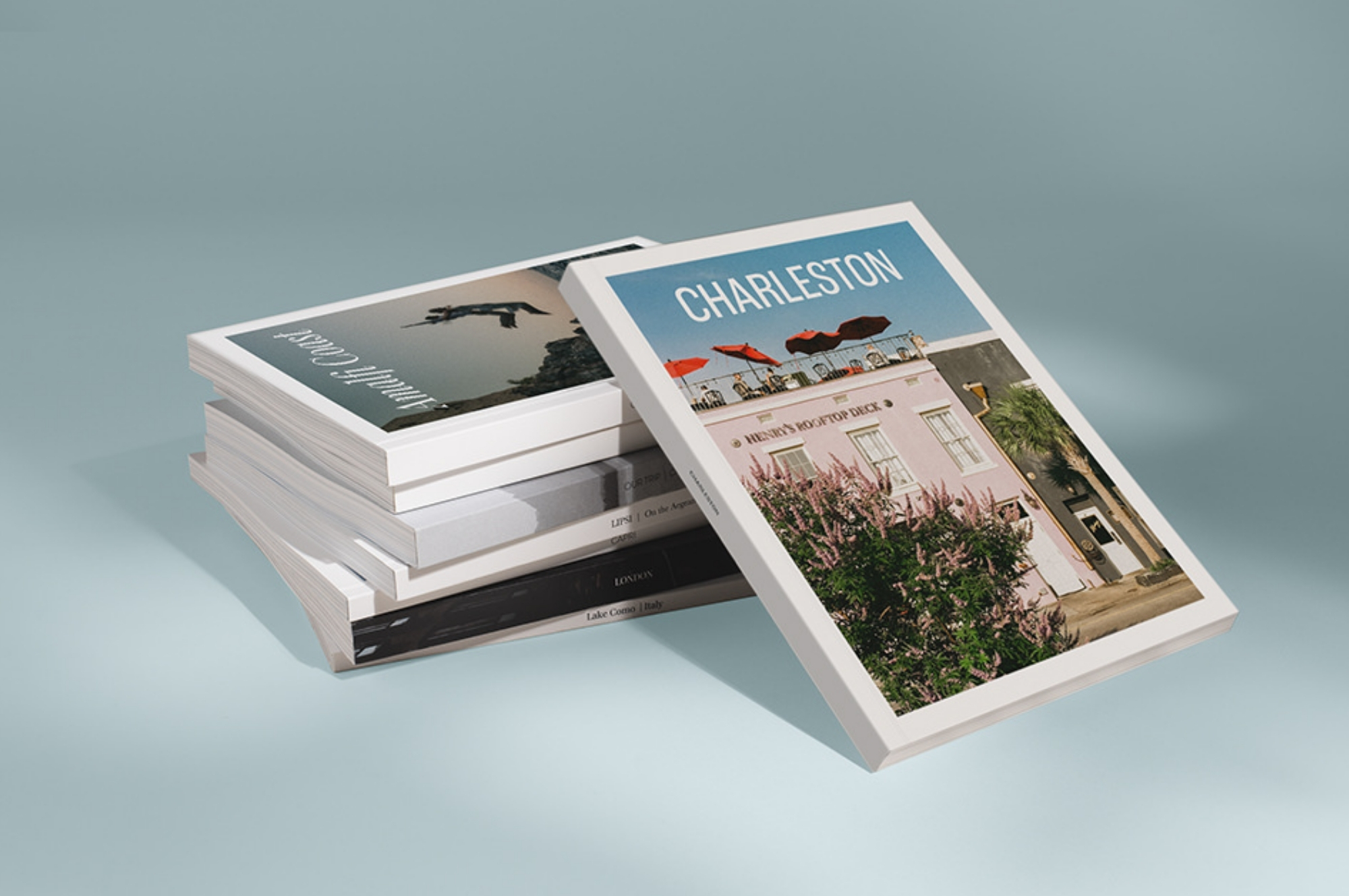 Stack of travel magazines on blue background.