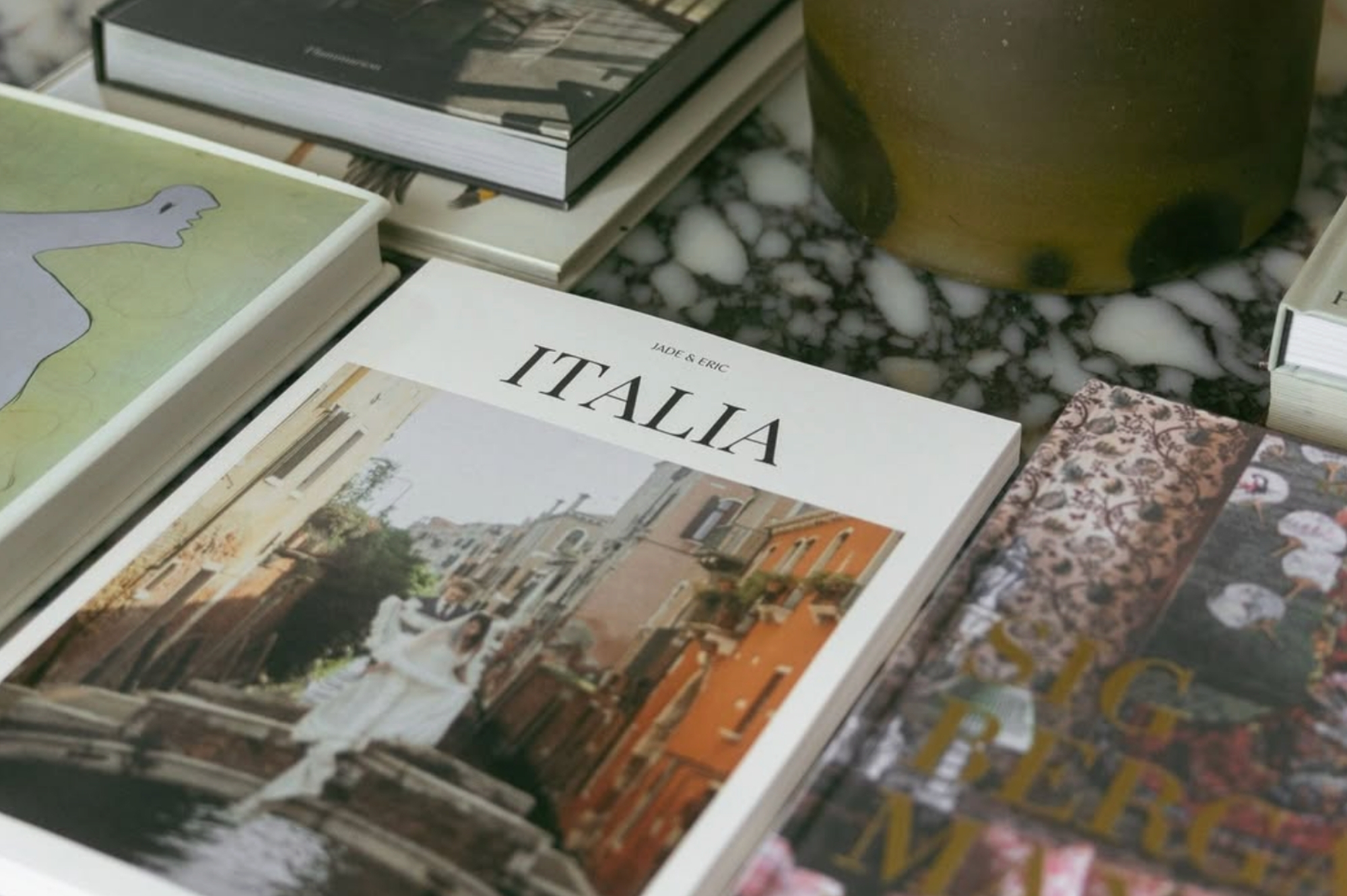 Several travel magazines laying on coffee table.