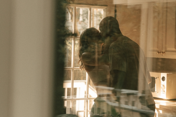 couple kissing in the window