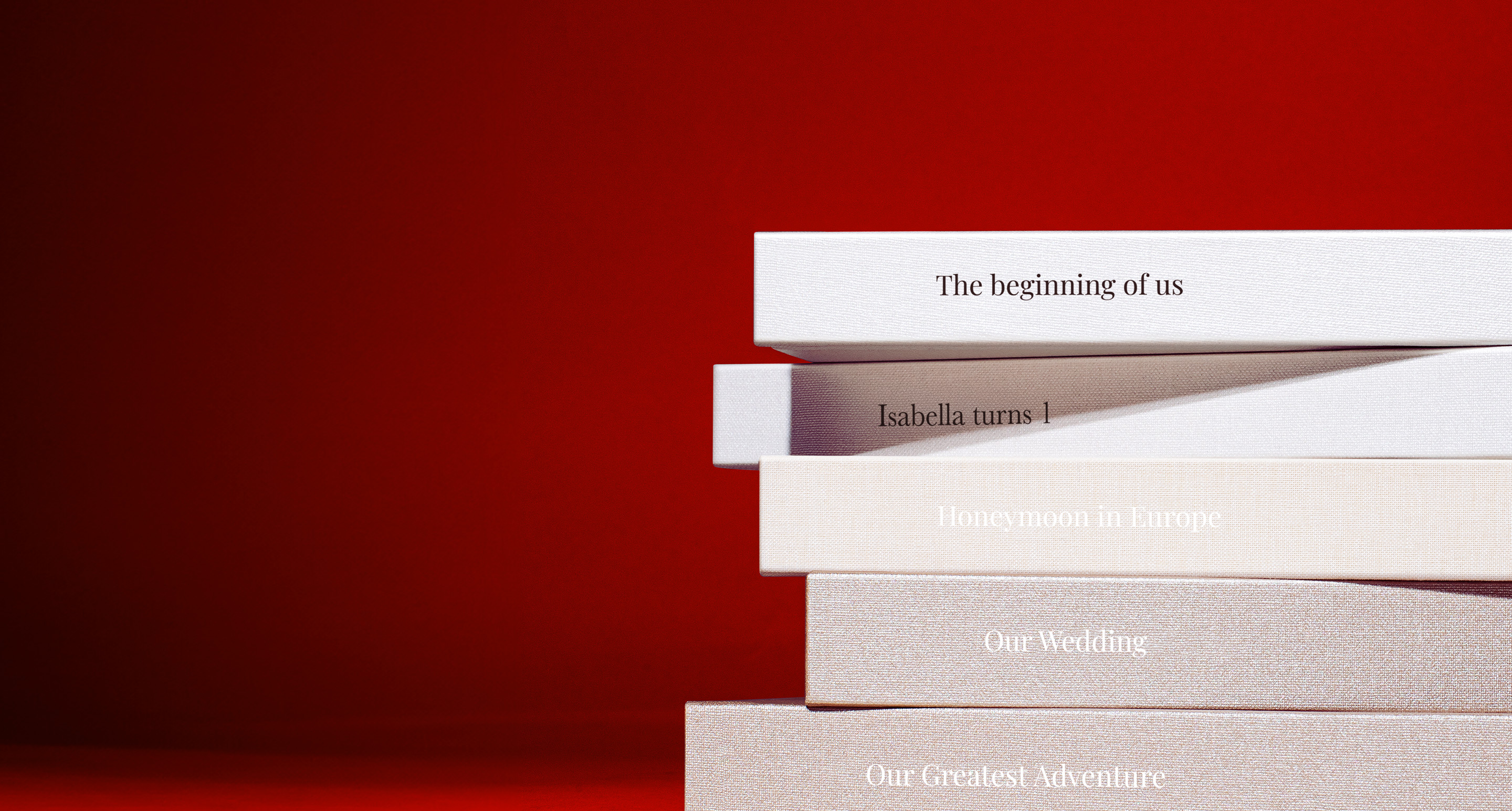 A stack of photo books with a red background