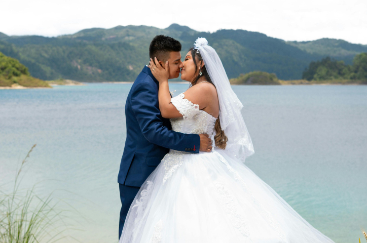 A couple at their ceremony almost kissing in front of the Queenstown lake